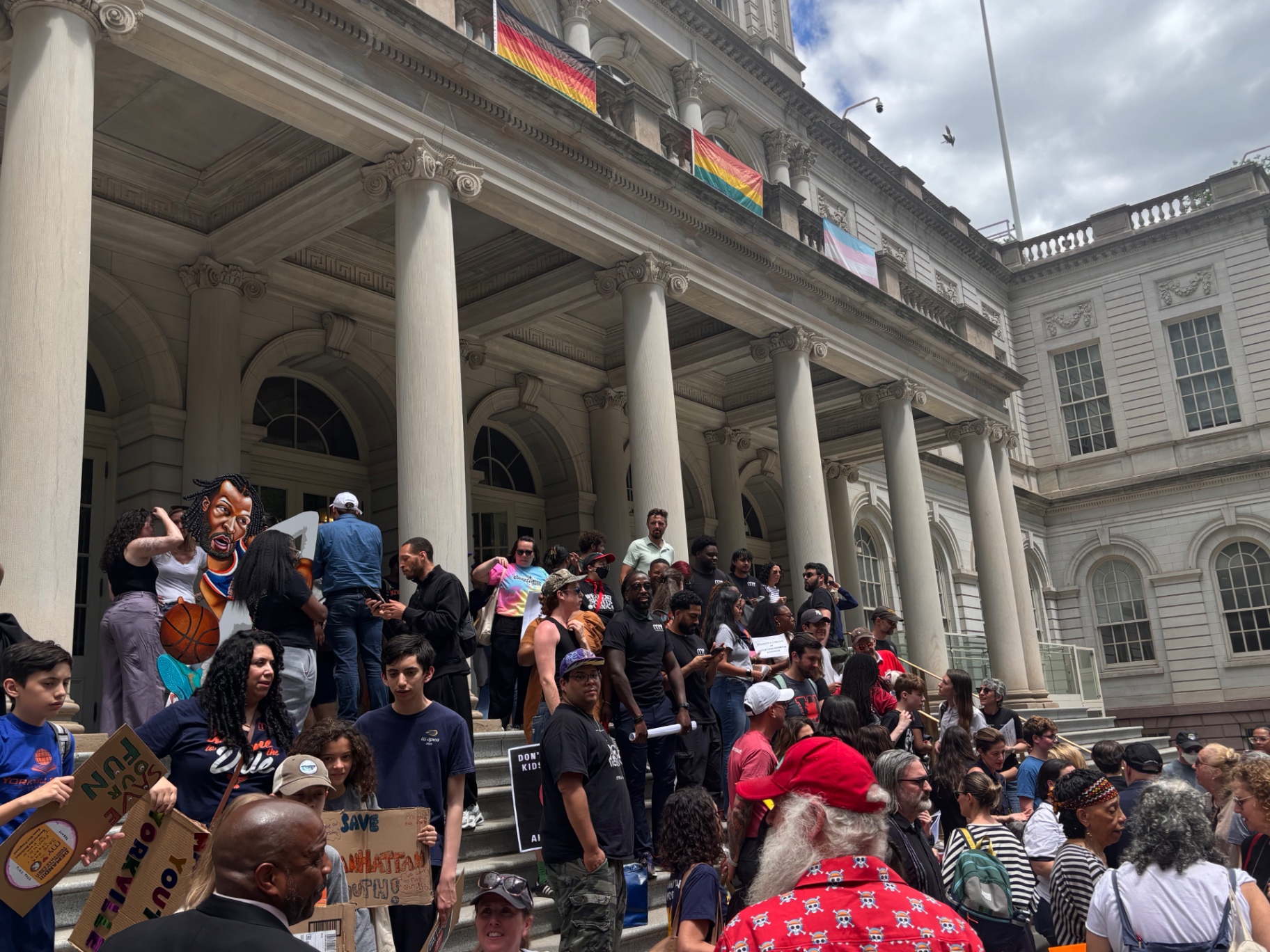 Homemade signs from Yorkville, Manhattan Youth, and District 2 families.