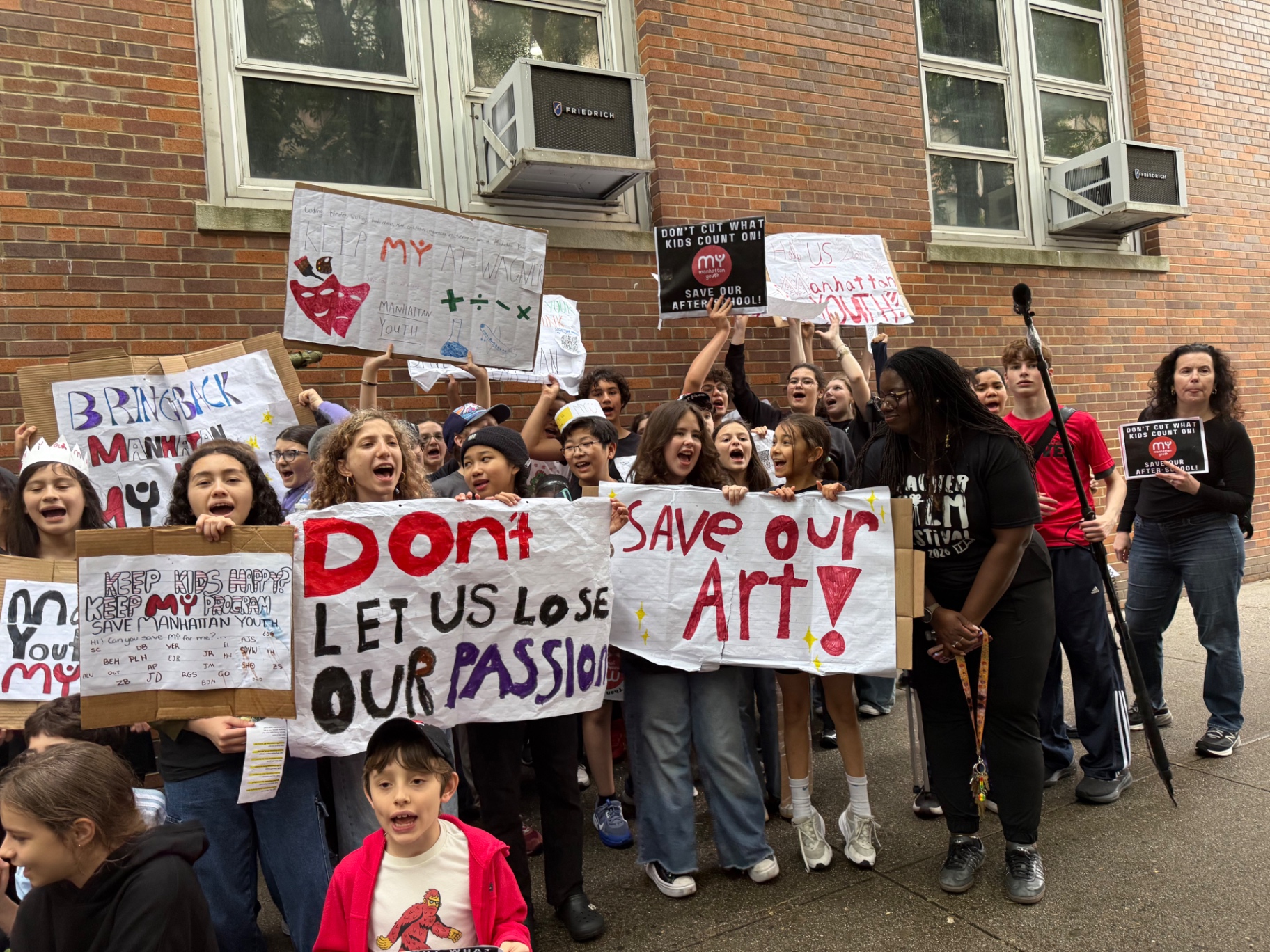 Families gathered outside J.H.S. 167 Robert F. Wagner for the Save Afterschool rally